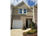 Charming townhome featuring a brick facade, attached garage, and well-maintained landscaping at 544 Magnolia Circle, Palmetto, GA 30268