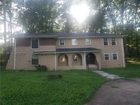 Spacious two-story home with a welcoming arched entryway, set in a beautiful wooded lot at 110 Chippewa Ct, Riverdale, GA 30296