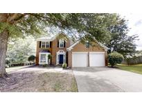 Two-story brick home with a manicured lawn and a two-car garage at 3001 Donamire Nw Ave, Kennesaw, GA 30144