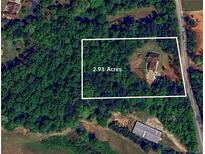 Beautiful 2.93 acre wooded lot with a traditional home with side-entry garage on John Rivers Rd in Dallas, GA at 6945 John Rivers Rd, Fairburn, GA 30213