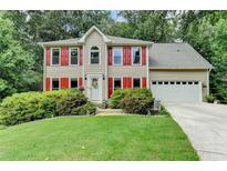 Charming two-story home with red shutters, manicured lawn, and attached two-car garage at 1019 Wolf Springs Ct, Lawrenceville, GA 30043