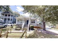 Charming home with inviting front porch, fresh paint, and well-manicured landscaping at 71 Thayer Se Ave, Atlanta, GA 30315