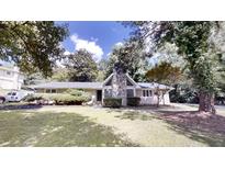 Charming single story home with mature trees, a stone chimney and a well manicured lawn at 366 O Brian Dr, Stone Mountain, GA 30088