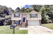 Charming split-level home features a well-manicured front yard and a classic brick and siding exterior at 488 Barclay Ct, Stone Mountain, GA 30083