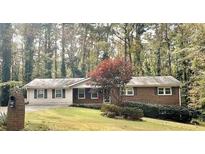 Charming single-story brick home with a well-maintained front yard and mature trees at 6174 S. Skyline Dr, Douglasville, GA 30135