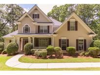 Charming two-story home with manicured landscaping and a welcoming front porch at 5581 Fox Glove Ct, Douglasville, GA 30135