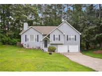 Charming two-story home featuring a well-manicured lawn and inviting curb appeal at 144 Boones Ridge Se Pkwy, Acworth, GA 30102