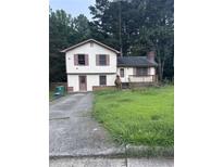 Two-story home featuring a quaint front porch and a driveway at 2169 Tiffany Ln, Lithonia, GA 30058