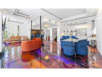 A spacious living room offers a sleek design with eye-catching floor, seating and open floorplan to kitchen and bar at 1231 Barnes Nw St, Atlanta, GA 30318