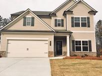 Charming two-story home featuring a two-car garage and a well-maintained front lawn at 126 Jacobs Ln, Loganville, GA 30052