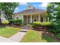 Charming home with a welcoming front porch and well-maintained landscaping, perfect for a cozy lifestyle at 615 Brookwater Dr, Stockbridge, GA 30281