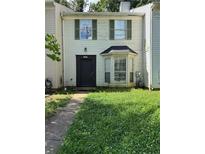 Two-story home featuring light siding, green shutters, and a bay window, presenting a traditional facade at 5597 Stonington Trace Pkwy, Stone Mountain, GA 30087
