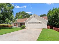 Charming one-story home with manicured lawn, red shutters, and a two-car garage at 7030 Kingston Ln, Mcdonough, GA 30253