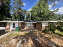 Charming single-story brick home featuring a well-maintained front yard and classic architectural details at 763 N Hairston Rd, Stone Mountain, GA 30083