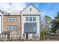 Charming multi-story townhouse with a combination of brick and light gray siding and fenced yard at 1762 Beckham Ne Pl, Atlanta, GA 30324