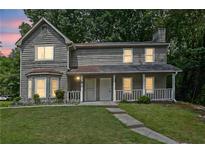 Charming two-story home featuring a welcoming front porch and well-maintained landscaping at 4520 Coopers Creek Se Cir, Smyrna, GA 30082