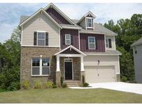 Charming two-story home with a brick and siding exterior, complemented by a well-manicured lawn at 4865 Fourth Rail Ln, Cumming, GA 30040