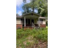 Charming single-story home featuring a cozy front porch and a combination of brick and siding exterior at 5103 Nw Berry Nw St, Covington, GA 30014