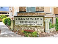 Stone Villa Sonoma Condominiums sign with landscaping and a view of the building at 10 Ne Perimeter Summit Blvd # 3107, Atlanta, GA 30319