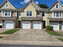 Charming townhomes featuring garages and landscaped front yards at 1865 Ellison Lakes Nw Ct # 21, Kennesaw, GA 30152