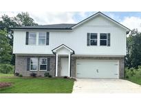 Two story home featuring a brick and white plank exterior, attached two car garage, and newly installed lawn at 107 Deer Xing, Temple, GA 30179