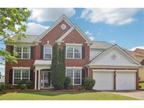 Charming two-story brick home with manicured lawn and attached two-car garage at 112 Rotherhithe Nw Ln, Marietta, GA 30066