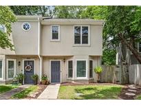 Charming townhome with a well-manicured lawn and inviting front door at 1002 Defoors Nw Lndg, Atlanta, GA 30318