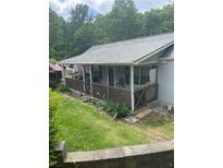 Inviting home featuring a charming covered front porch with a wood railing and landscaped yard at 36 Wolf Pen Path, Dallas, GA 30157