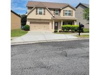 Charming two-story home with a brick and siding exterior and a well-maintained front yard at 948 Regency Dr, Lawrenceville, GA 30044