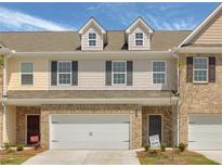 Charming townhome featuring a two-car garage and classic brick and siding details at 2841 Fareed, Douglasville, GA 30135