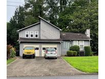 Two-story home with neutral siding, two-car garage, and an ample front yard at 2977 Lowe Trail Ne Trl, Marietta, GA 30066