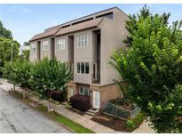 Attractive three-story townhome with a modern design and a combination of brick and gray stucco facade at 616 Angier Ne Ave # 4, Atlanta, GA 30308