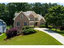 Beautiful two-story brick home with manicured lawn and mature trees in a desirable neighborhood at 650 Chestatee Creek Nw Dr, Acworth, GA 30101