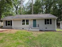Charming single-story home with freshly painted exterior and well-maintained front lawn at 2943 Westbury Dr, Decatur, GA 30033