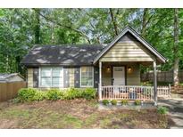 Charming cottage-style home with a cozy front porch and well-maintained landscaping at 778 Mclendon Dr, Decatur, GA 30079