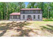 Charming two-story home featuring gray siding, black trim, and a well-maintained lawn at 155 N Fayette Dr, Fayetteville, GA 30214