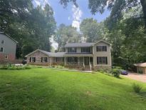 Charming two-story home with a landscaped front yard and inviting front porch at 4147 Scofield Pl, Stonecrest, GA 30083