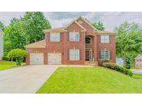 Charming two-story brick home with a well-manicured lawn and a three car garage at 10950 Glenhurst, Duluth, GA 30097