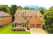 Charming home featuring a brick and stone facade, complemented by a well-manicured lawn and a two-car garage at 4978 Arborview Pkwy, Acworth, GA 30101
