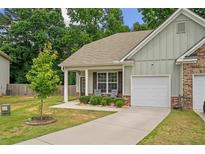 Charming single-story home with a well-maintained front yard, covered porch, and attached one car garage at 560 Vandenburg Dr, Villa Rica, GA 30180