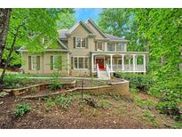 Inviting home with a charming porch and landscaped front yard at 1170 Spring Oak Way, Cumming, GA 30041