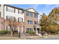 Charming multi-story brick townhome with well-manicured landscaping and inviting entrance at 5667 Cascade Sw Run, Atlanta, GA 30336