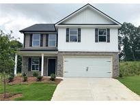 Charming two-story home featuring a two-car garage and landscaped front yard at 123 Deer Xing, Temple, GA 30179