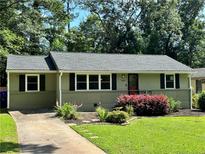 Charming single-story home with a manicured lawn, tidy landscaping, and a freshly painted exterior at 2985 Westbury Dr, Decatur, GA 30033