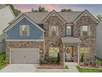 Charming brick and blue two-story home boasts a well-manicured lawn and inviting entryway at 4824 Sultana Sw Way, Atlanta, GA 30331