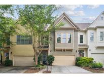 Inviting townhome with attached garage and well-maintained landscaping for great curb appeal at 1028 Constitution Way, Cumming, GA 30040