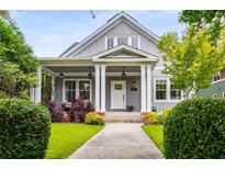 Charming home with a covered front porch, lush landscaping, and a well-maintained lawn at 1338 Iverson Ne St, Atlanta, GA 30307