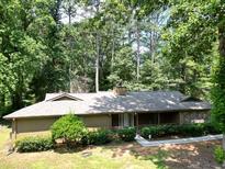 Ranch-style home boasts a welcoming front porch and beautiful stone accents at 4525 N Landing Dr, Marietta, GA 30066
