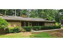 Charming single-story home featuring a stone accent wall, covered porch, and well-maintained landscaping at 4525 N Landing Dr, Marietta, GA 30066