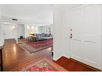Bright living room with a decorative rug, comfortable sofa and natural light at 52 Chaumont Nw Sq, Atlanta, GA 30327